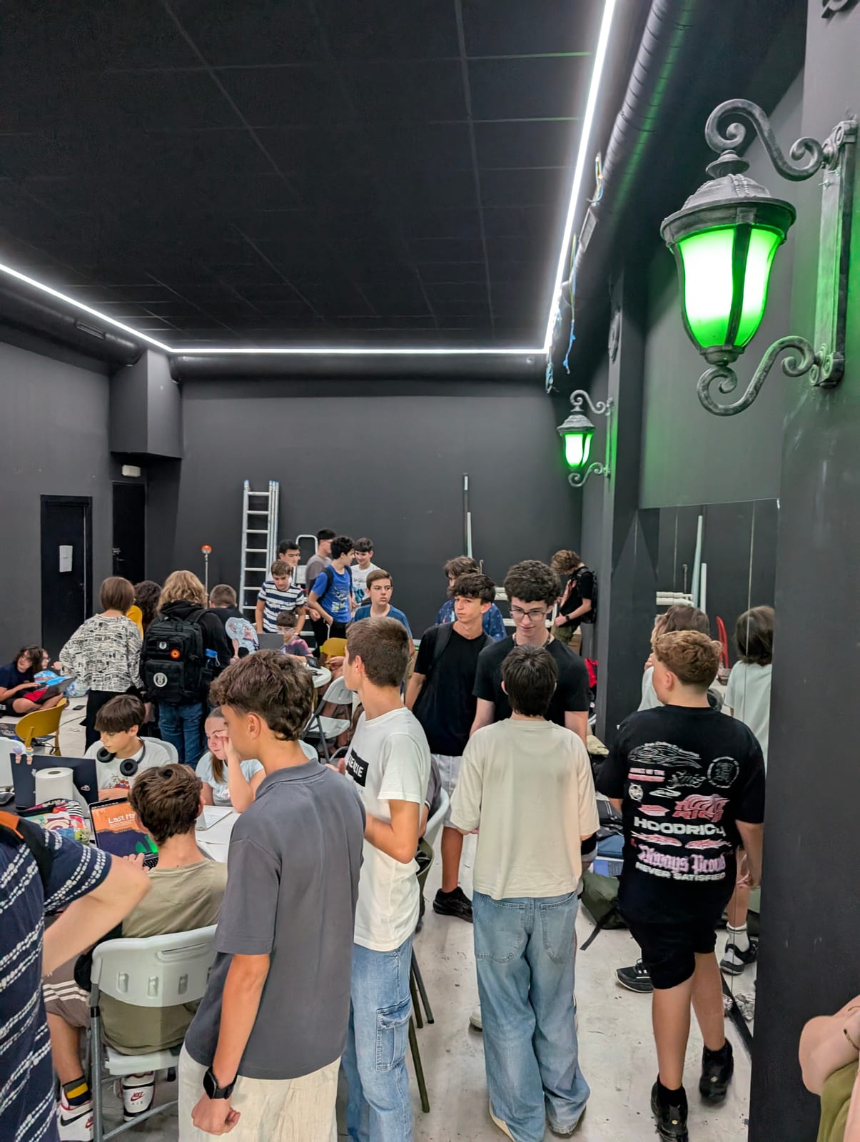Participants gather in a green-lit room during Daydream Valencia game jam.